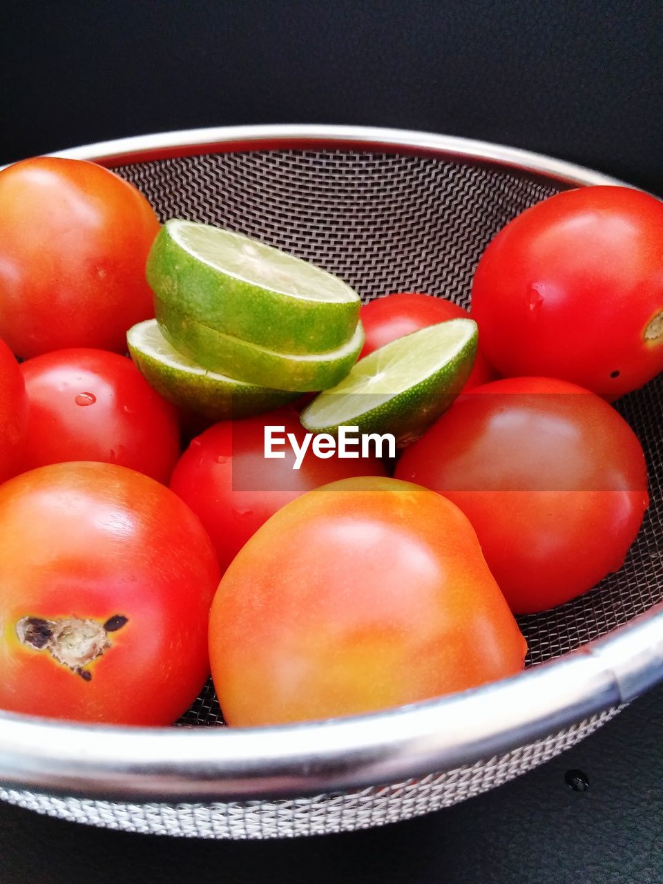 CLOSE-UP OF TOMATOES ON RED SURFACE