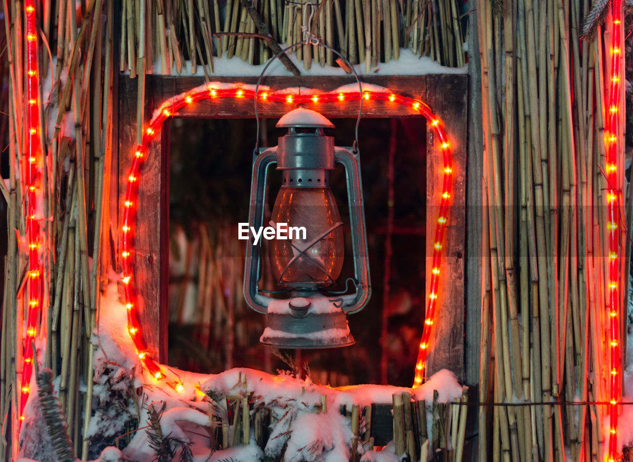 CLOSE-UP OF ILLUMINATED RED LIGHT CANDLES