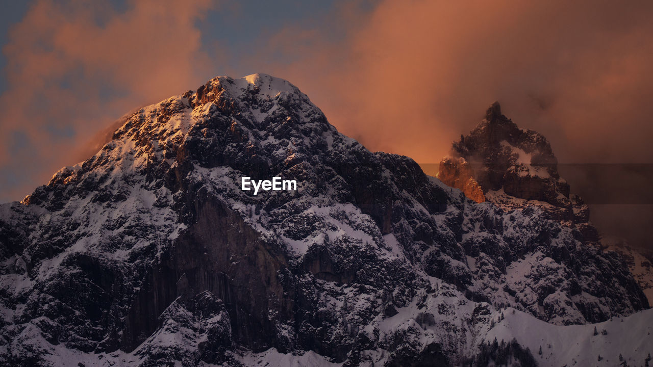 Scenic view of snowcapped mountains against sky during sunset 