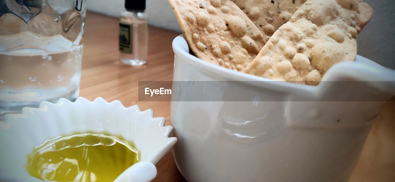 CLOSE-UP OF COFFEE CUP AND GLASS