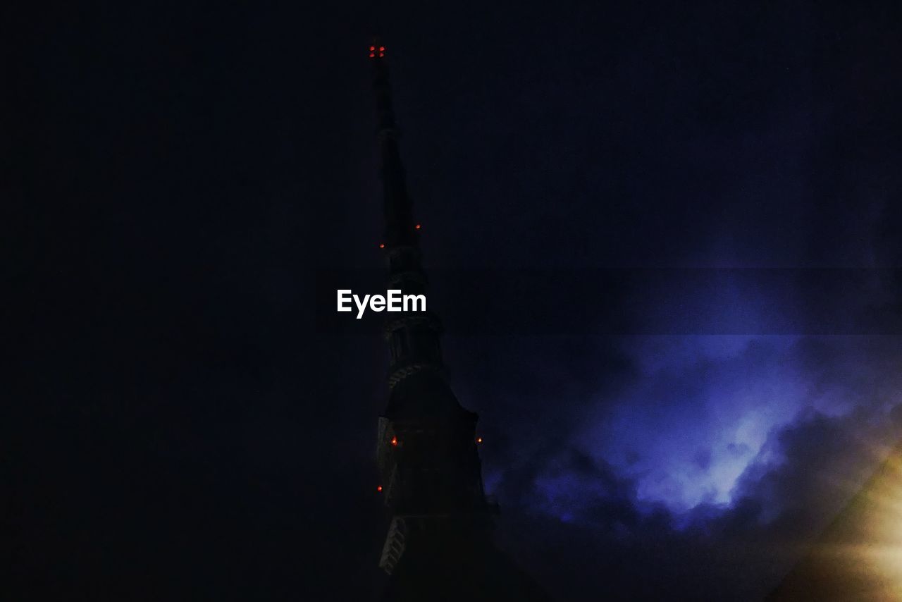 LOW ANGLE VIEW OF ILLUMINATED BUILDING AGAINST SKY