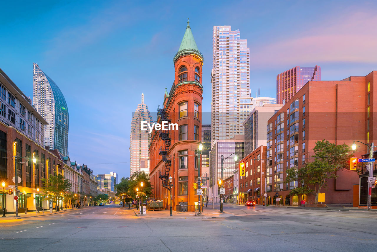 Illuminated buildings in city at dusk