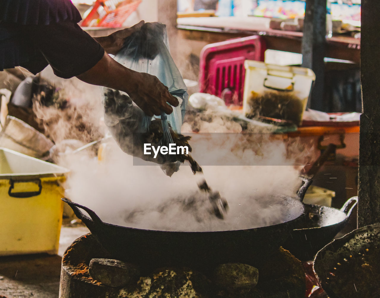 Midsection of man preparing food in kitchen