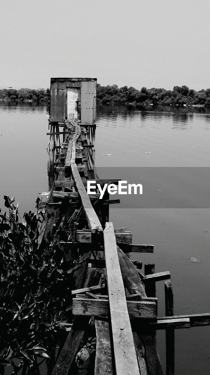 Pier on lake against sky