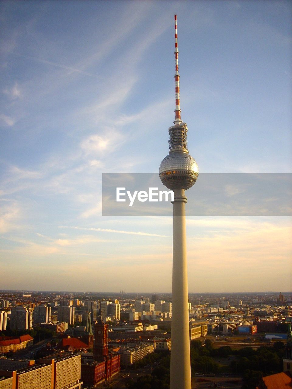Fernsehturm and buildings in city against sky