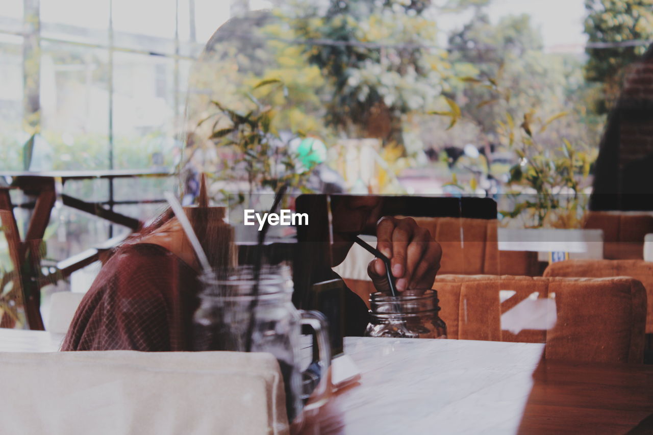 Digital composite image of woman and tree at restaurant