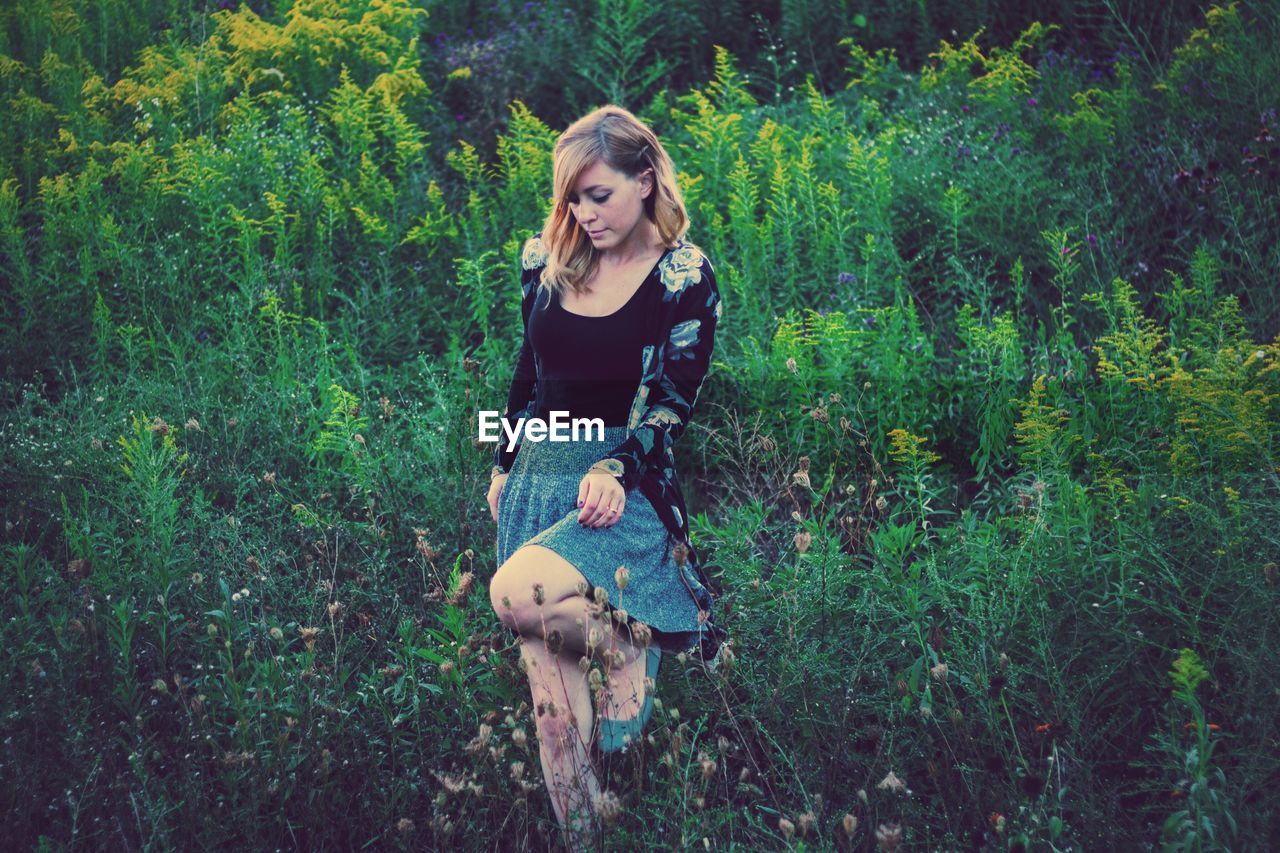 Young woman walking in field