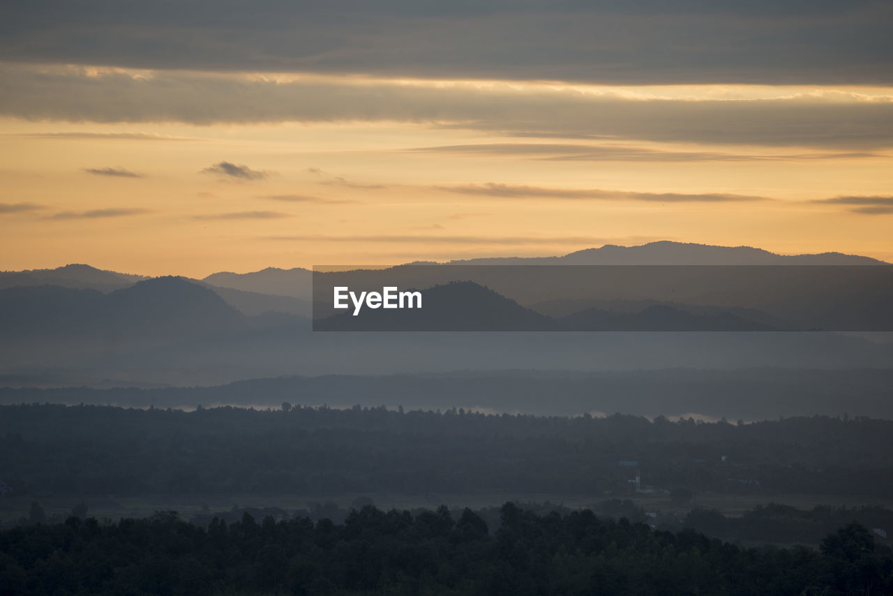mountain, environment, scenics - nature, sky, beauty in nature, landscape, sunrise, fog, nature, tranquility, mountain range, morning, cloud, dawn, tranquil scene, tree, land, no people, sun, plant, idyllic, outdoors, travel, horizon, sunlight, forest, twilight, mist, silhouette, travel destinations, non-urban scene, dramatic sky, tourism, atmospheric mood, mountain peak, high angle view, orange color, sunbeam, remote