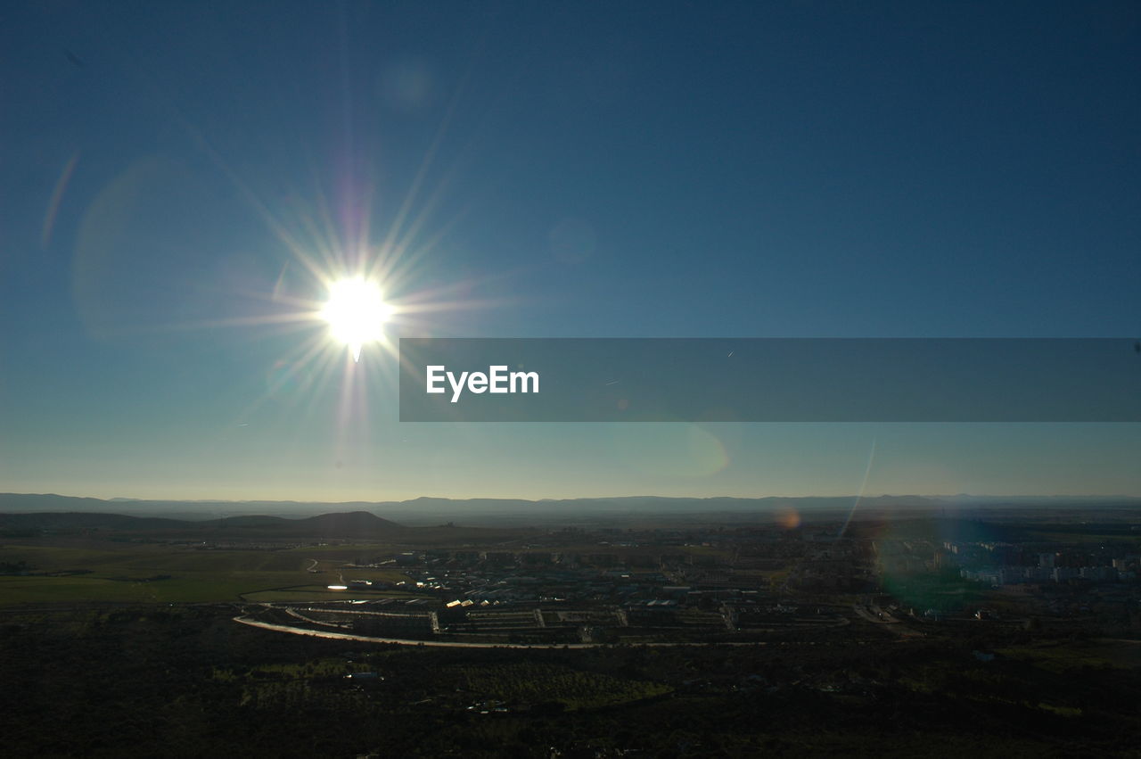 High angle view of buildings against sky during sunny day