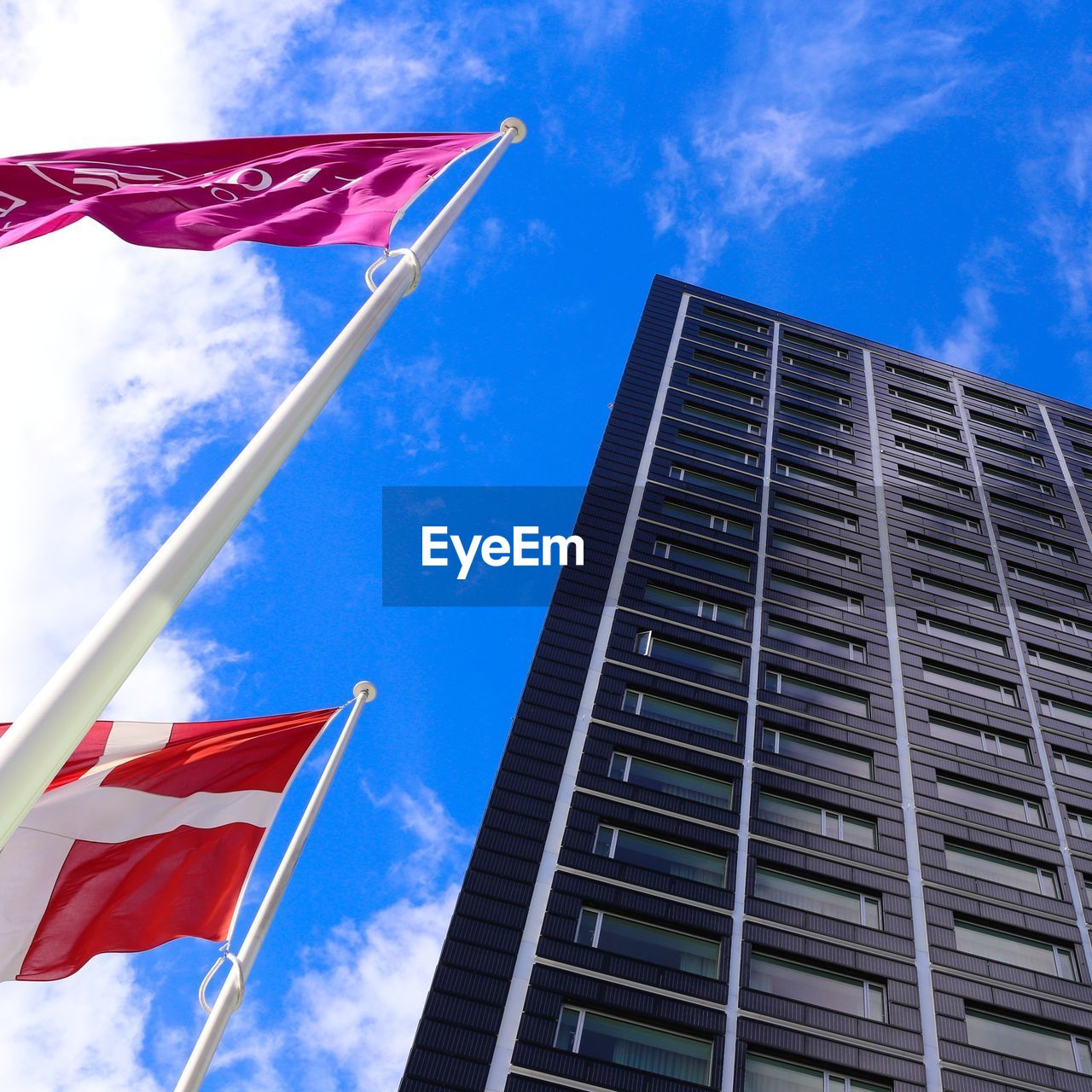 Danish flag in front of skyscraper