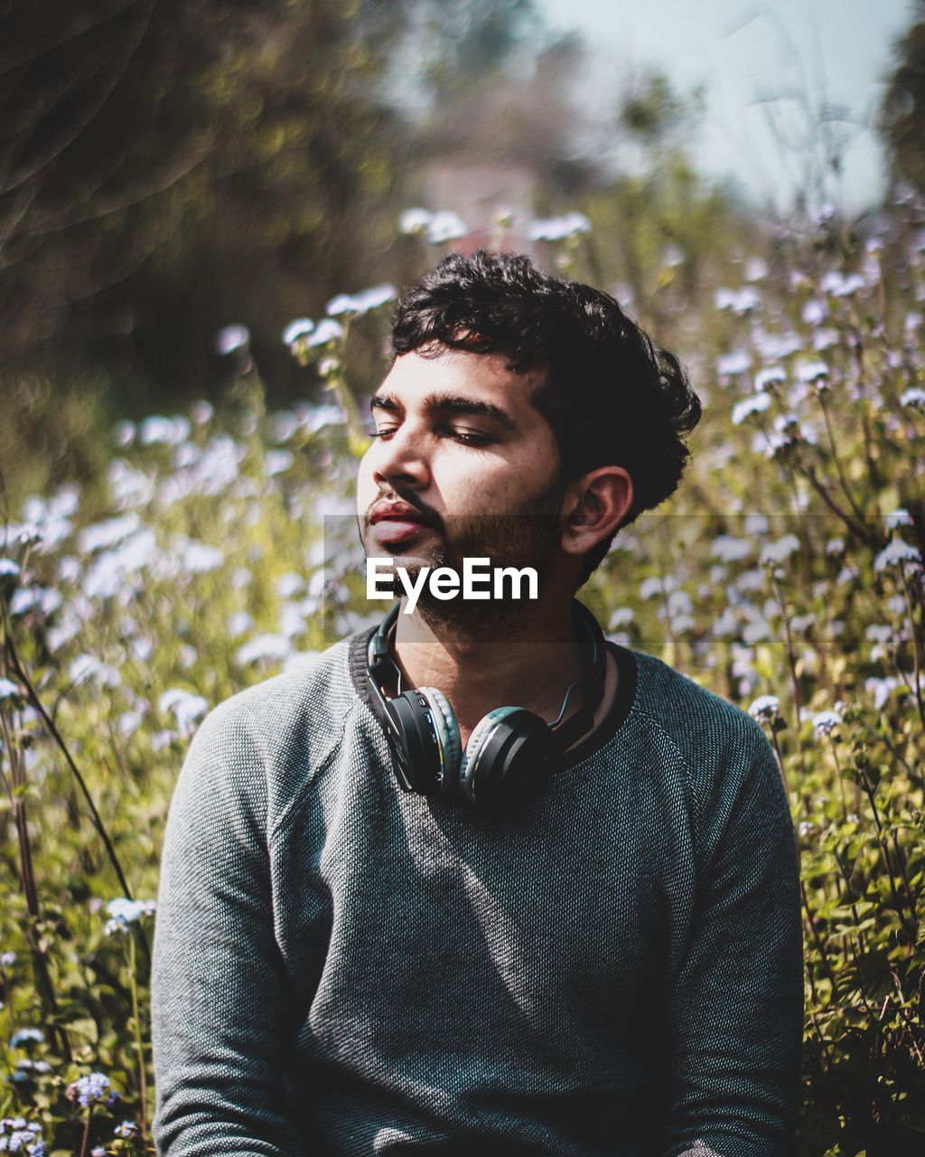 Portrait of young man looking away in forest