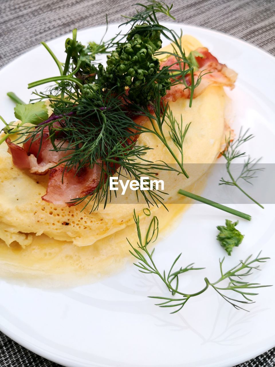 High angle view of fresh vegetables in omelet in plate on table