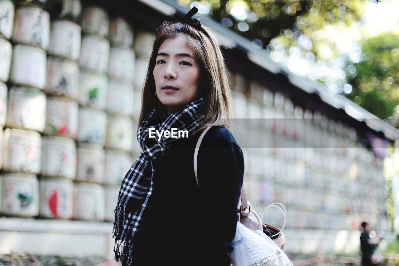 Portrait of young woman standing outdoors