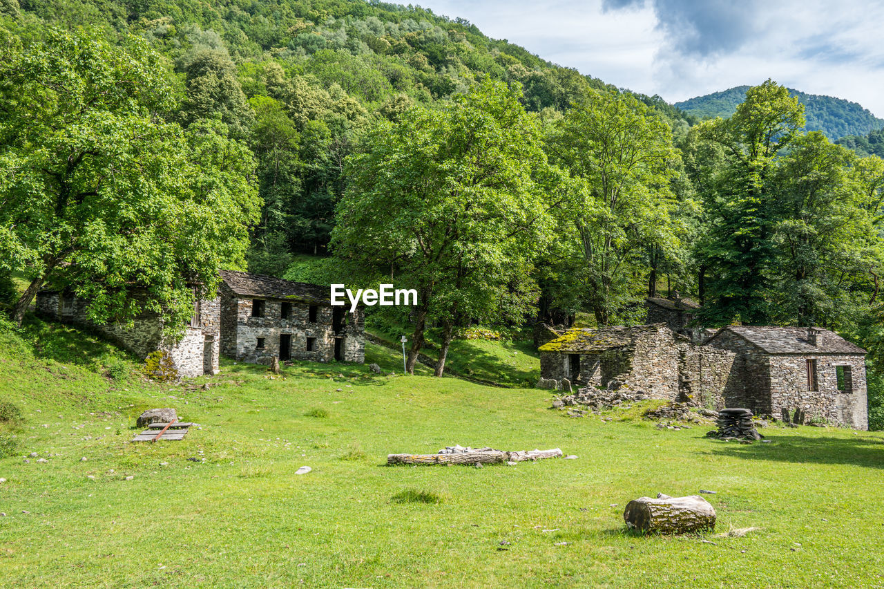 Ruined stone houses and mills in an abandoned mountain village in the alps