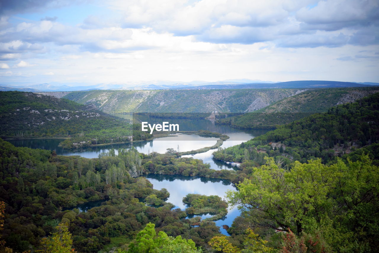 Scenic view of lake and mountains against sky