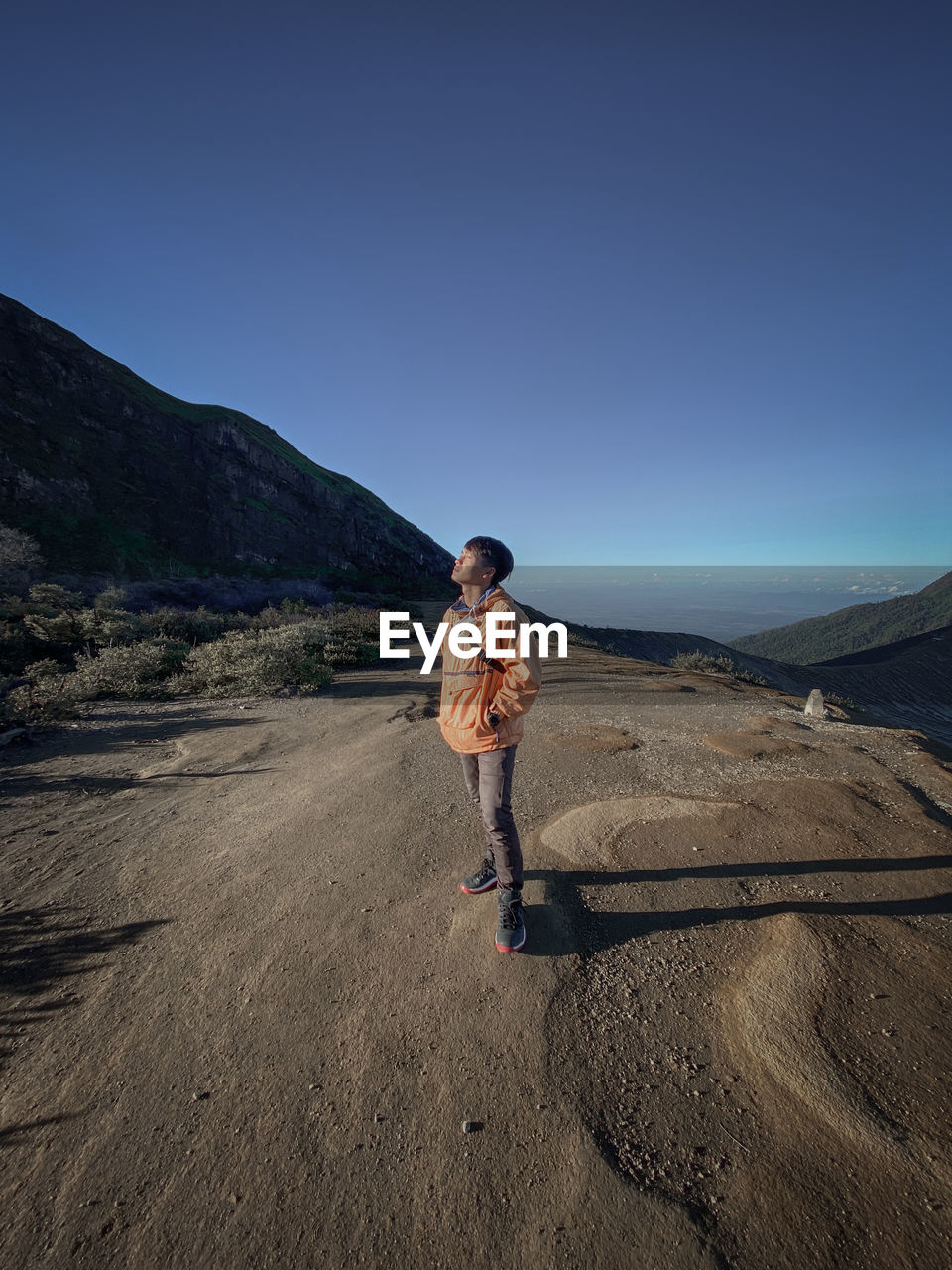 Full length of man standing on land against sky