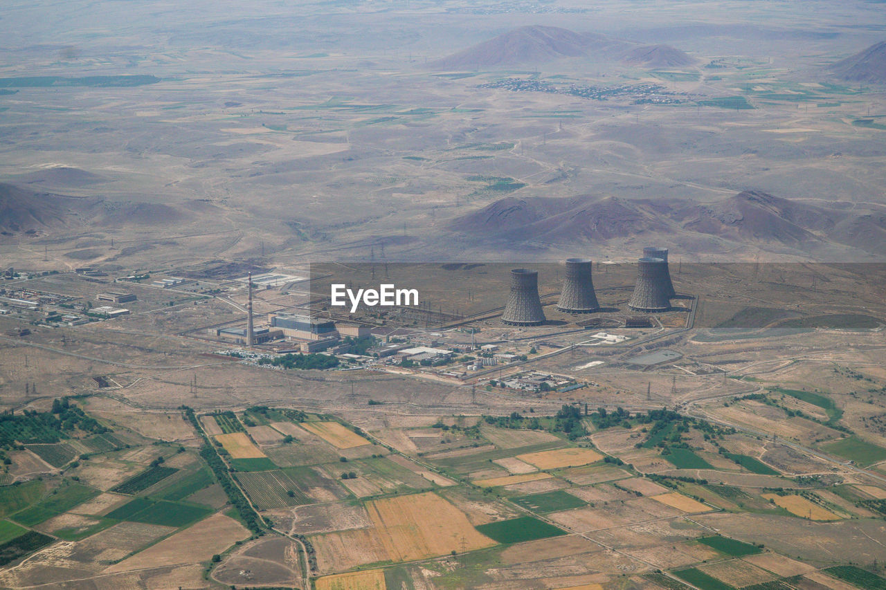 High angle view of power plant with agricultural fields around