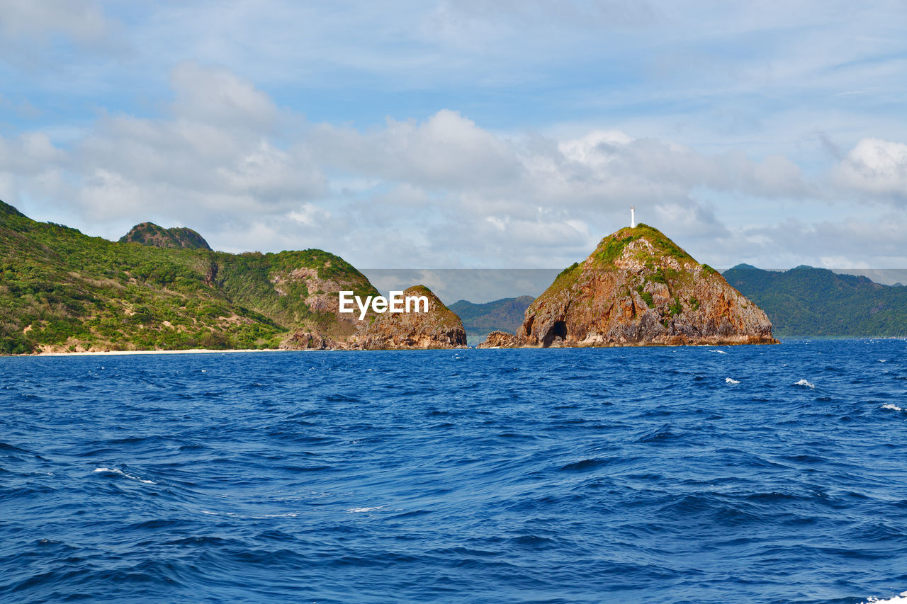 PANORAMIC VIEW OF SEA AND ROCK FORMATION AGAINST SKY