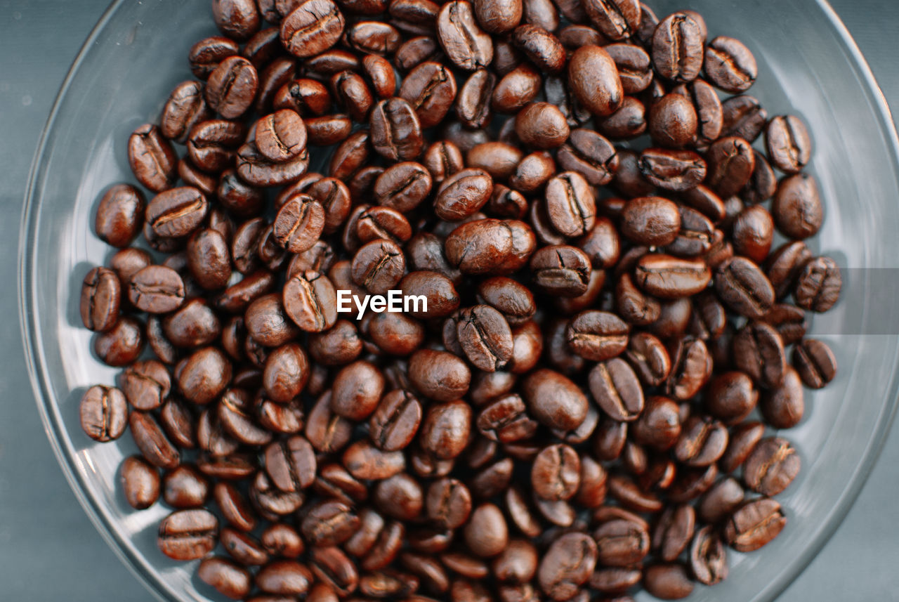 CLOSE-UP OF COFFEE BEANS IN CONTAINER