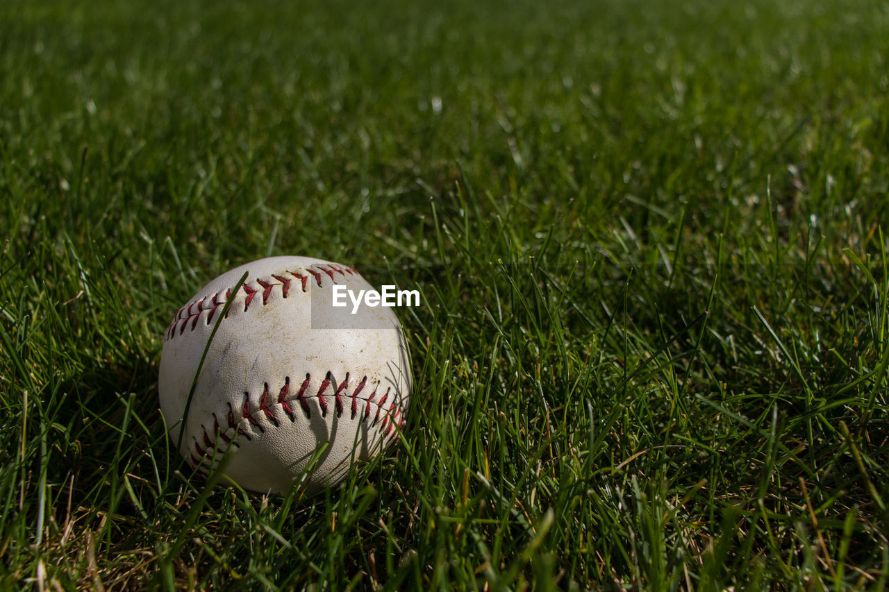 Close-up of baseball ball on field