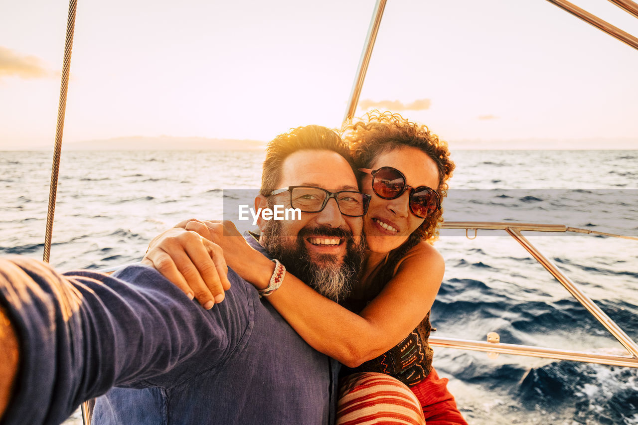 Portrait of smiling couple on boat in sea