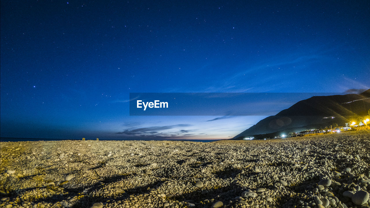 Scenic view of field against sky at night