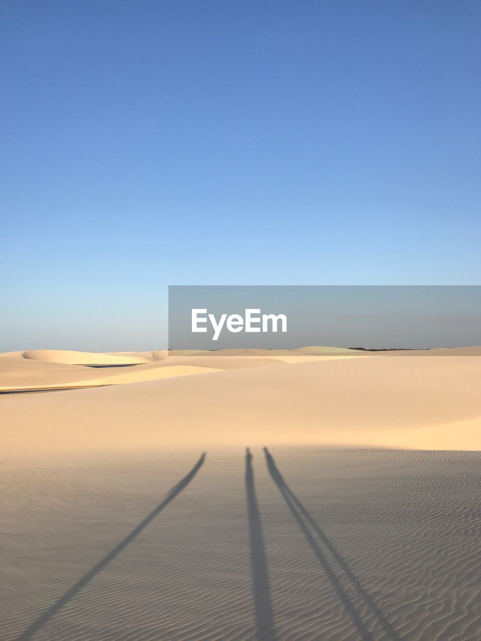 Scenic view of desert against clear blue sky