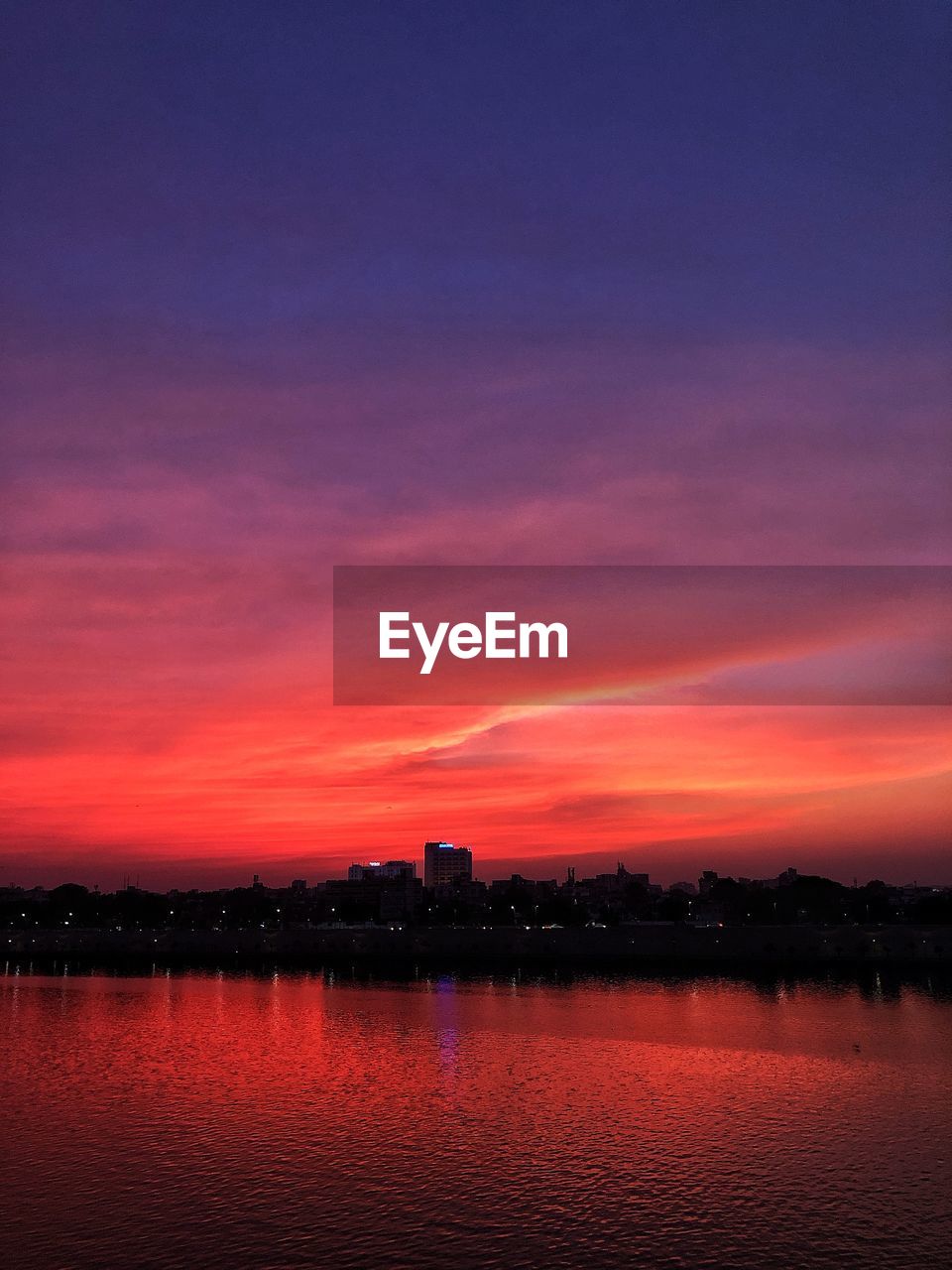 Scenic view of lake against romantic sky at sunset