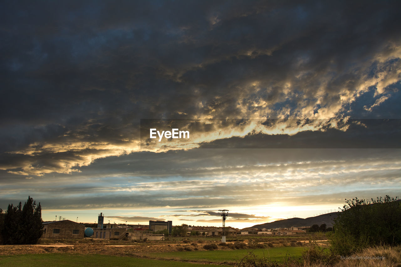 Scenic view of townscape against sky during sunset