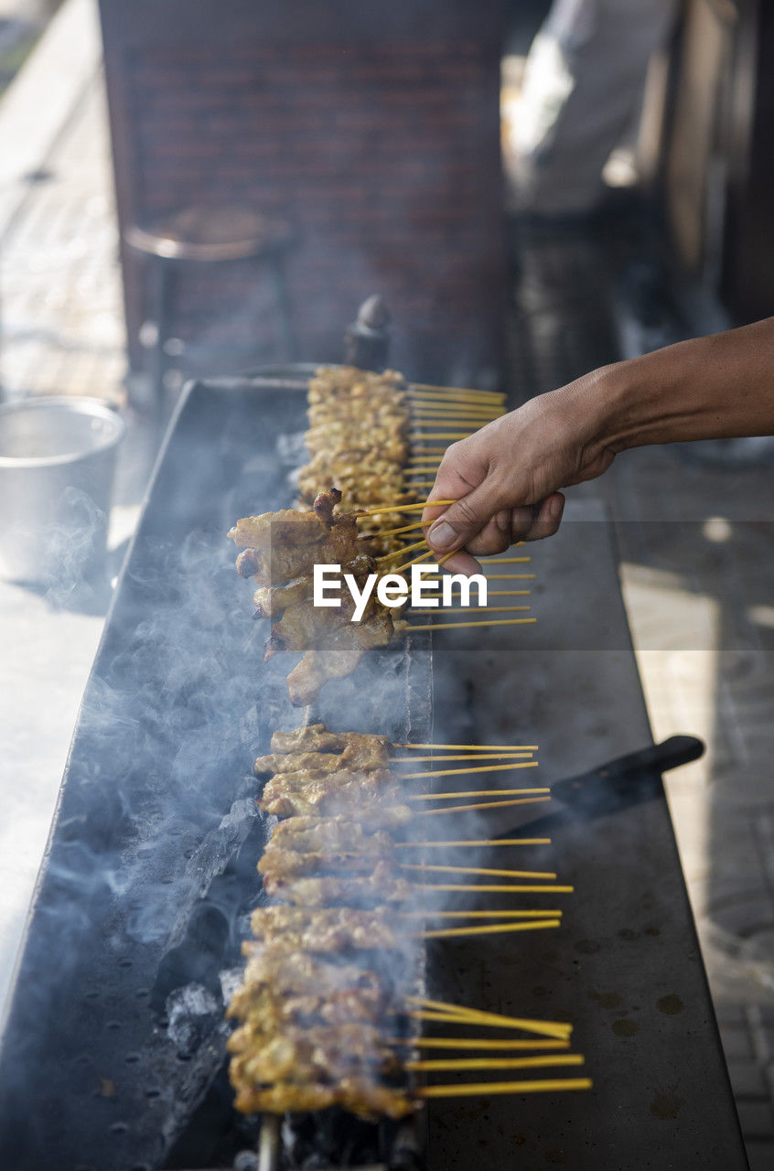 cropped hand of man preparing food