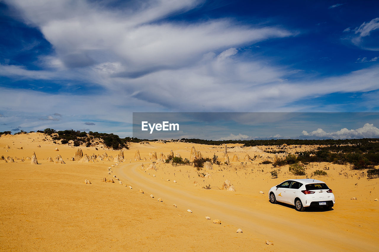 Cars on road against sky