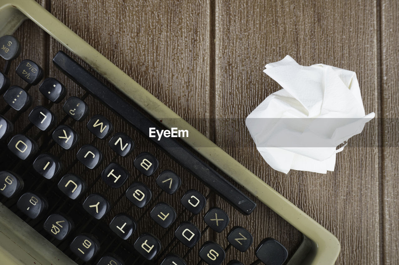 High angle view of typewriter with crumpled paper on table