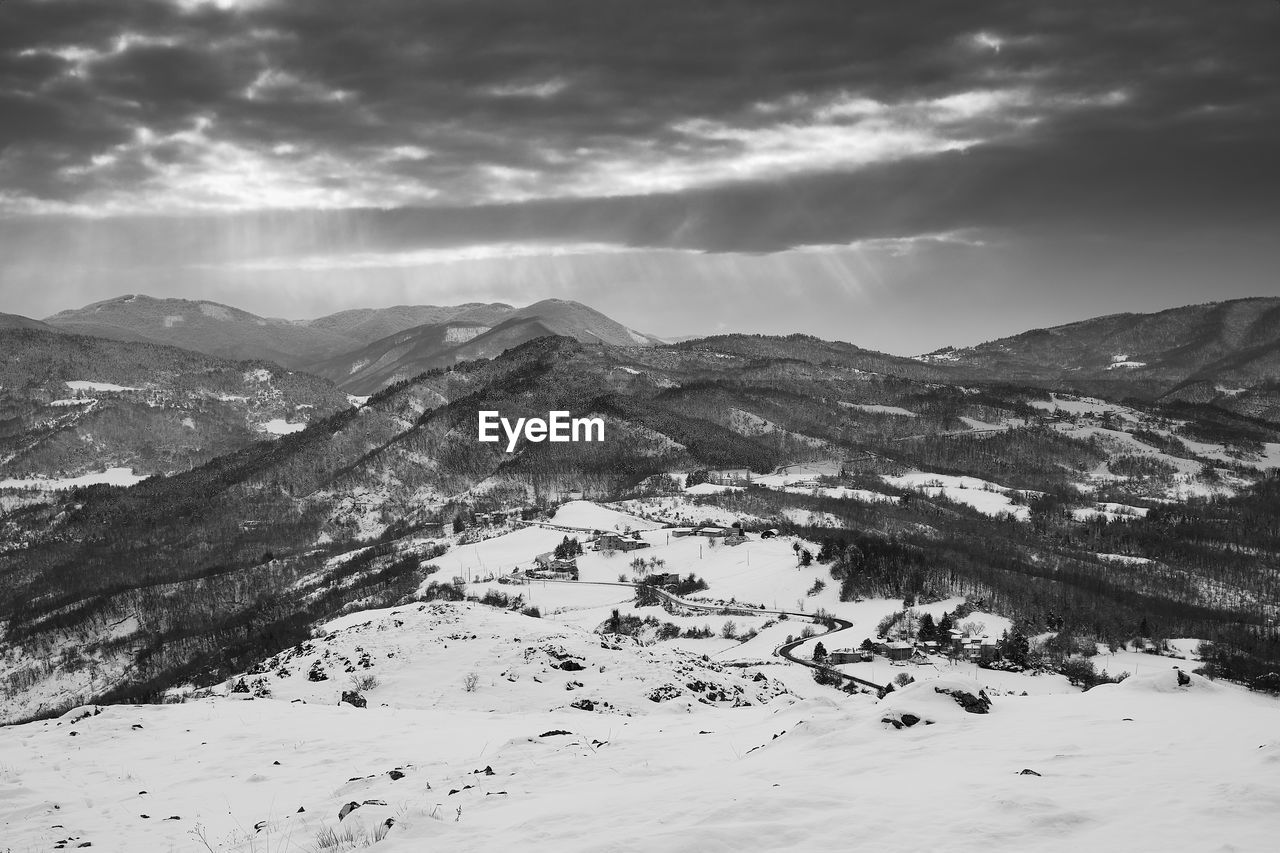 Scenic view of snow covered mountains against sky