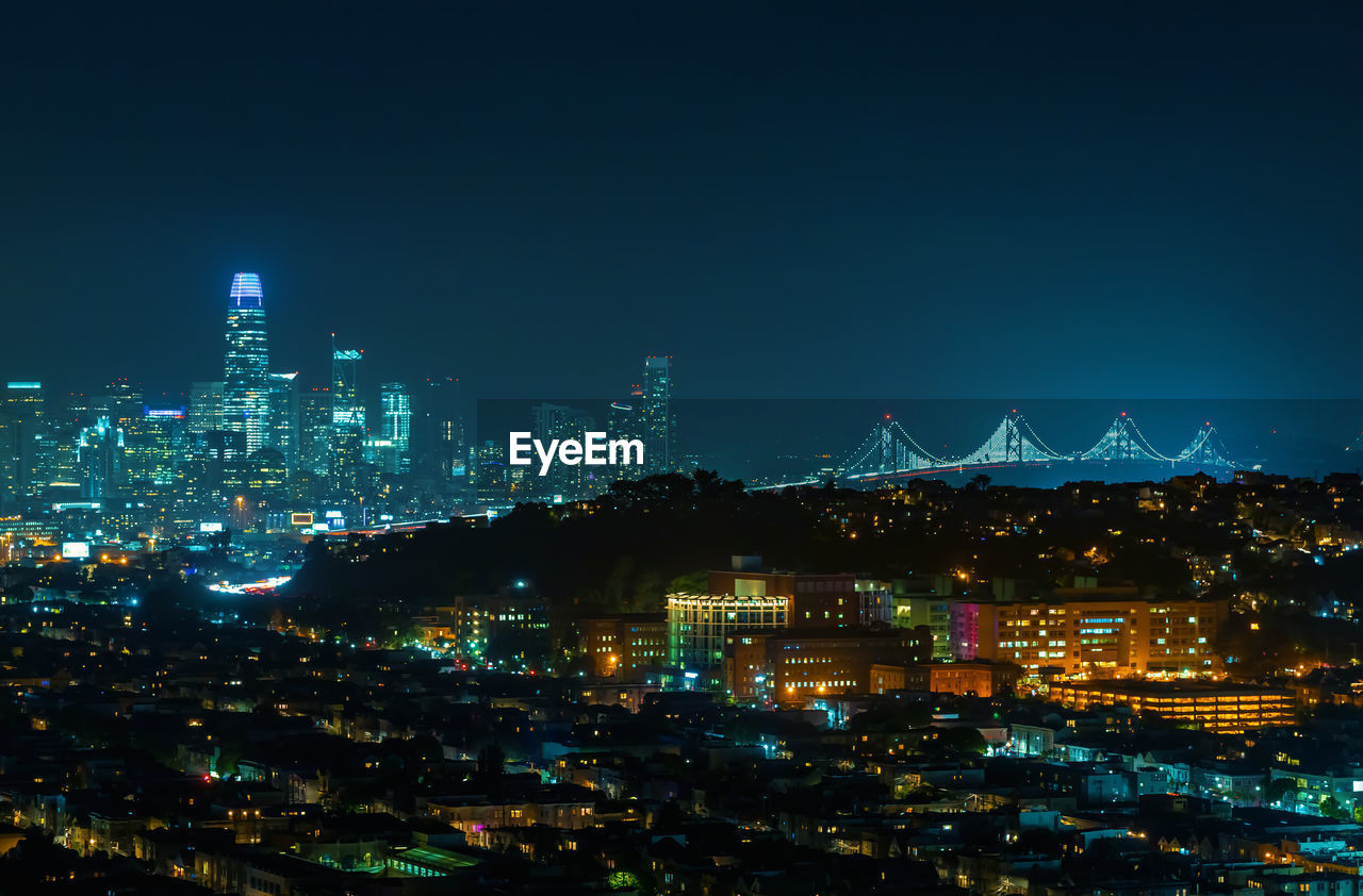 Aerial view of townscape against sky at night