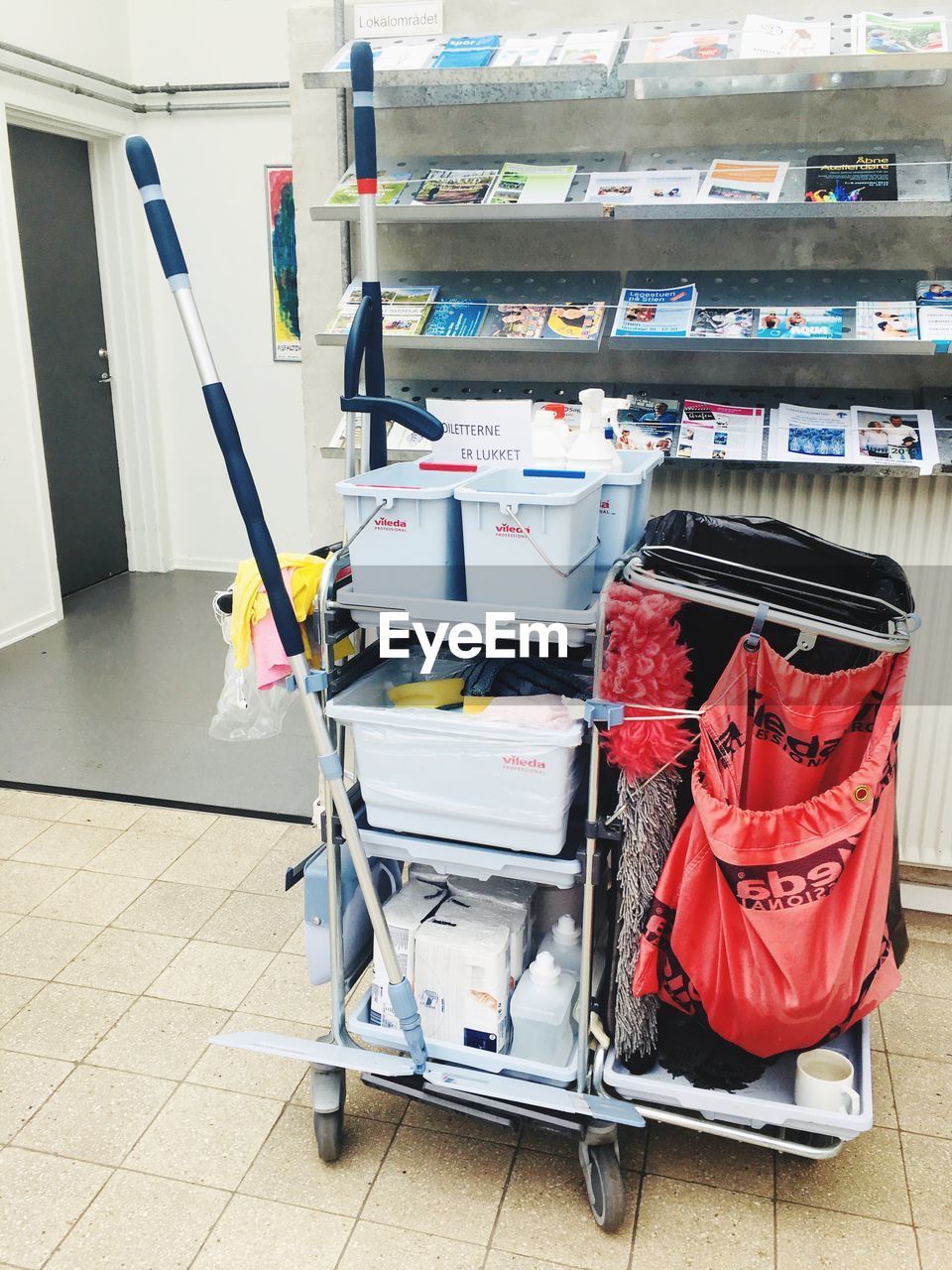 STACK OF BOOKS ON TABLE BY RACK