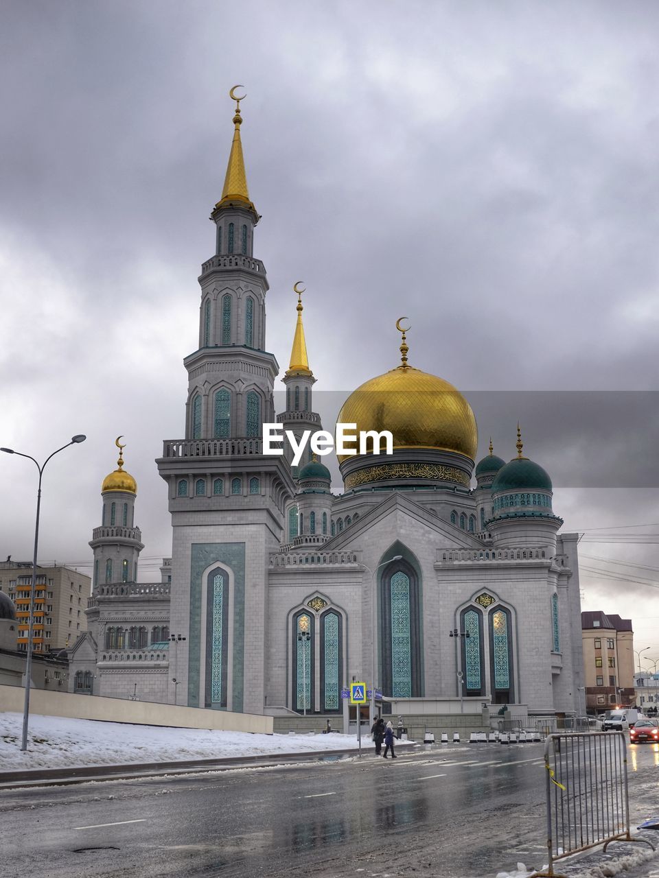 Low angle view of mosque against clouds