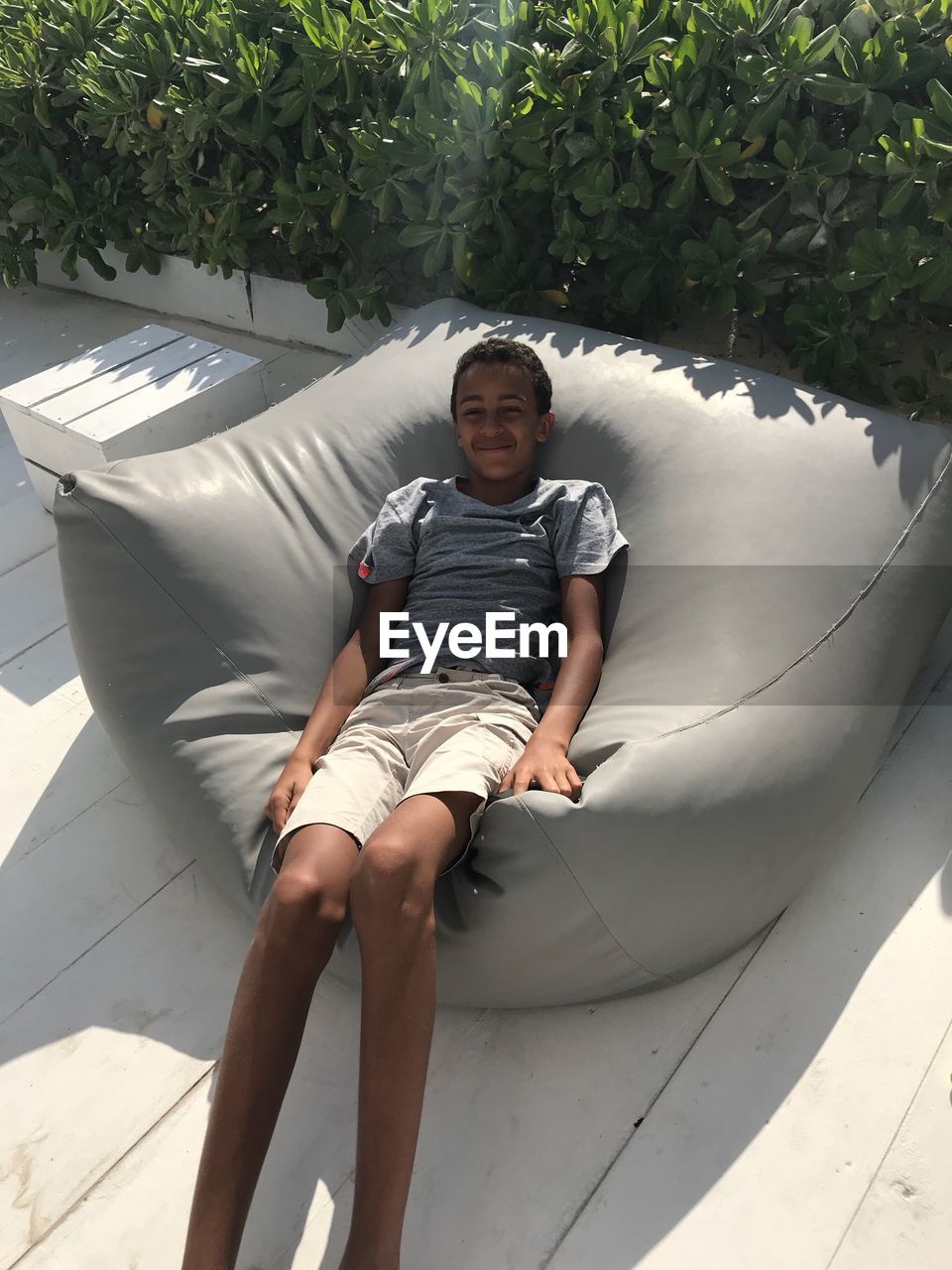 Portrait of smiling boy relaxing on bean bag