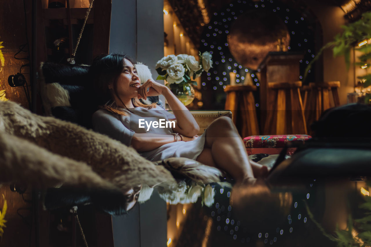 Young woman relaxing on sofa at home