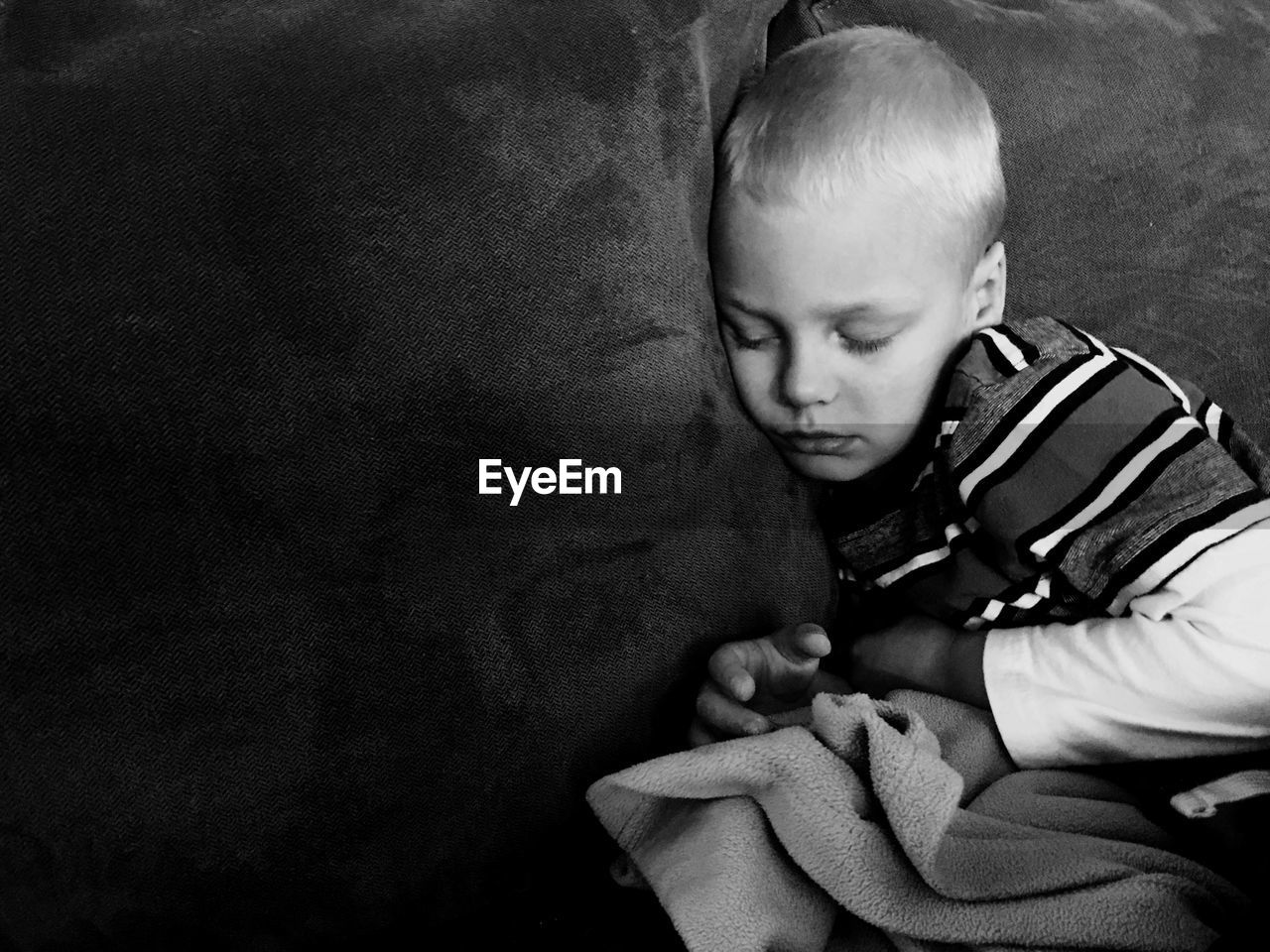 High angle view of boy sleeping on sofa at home