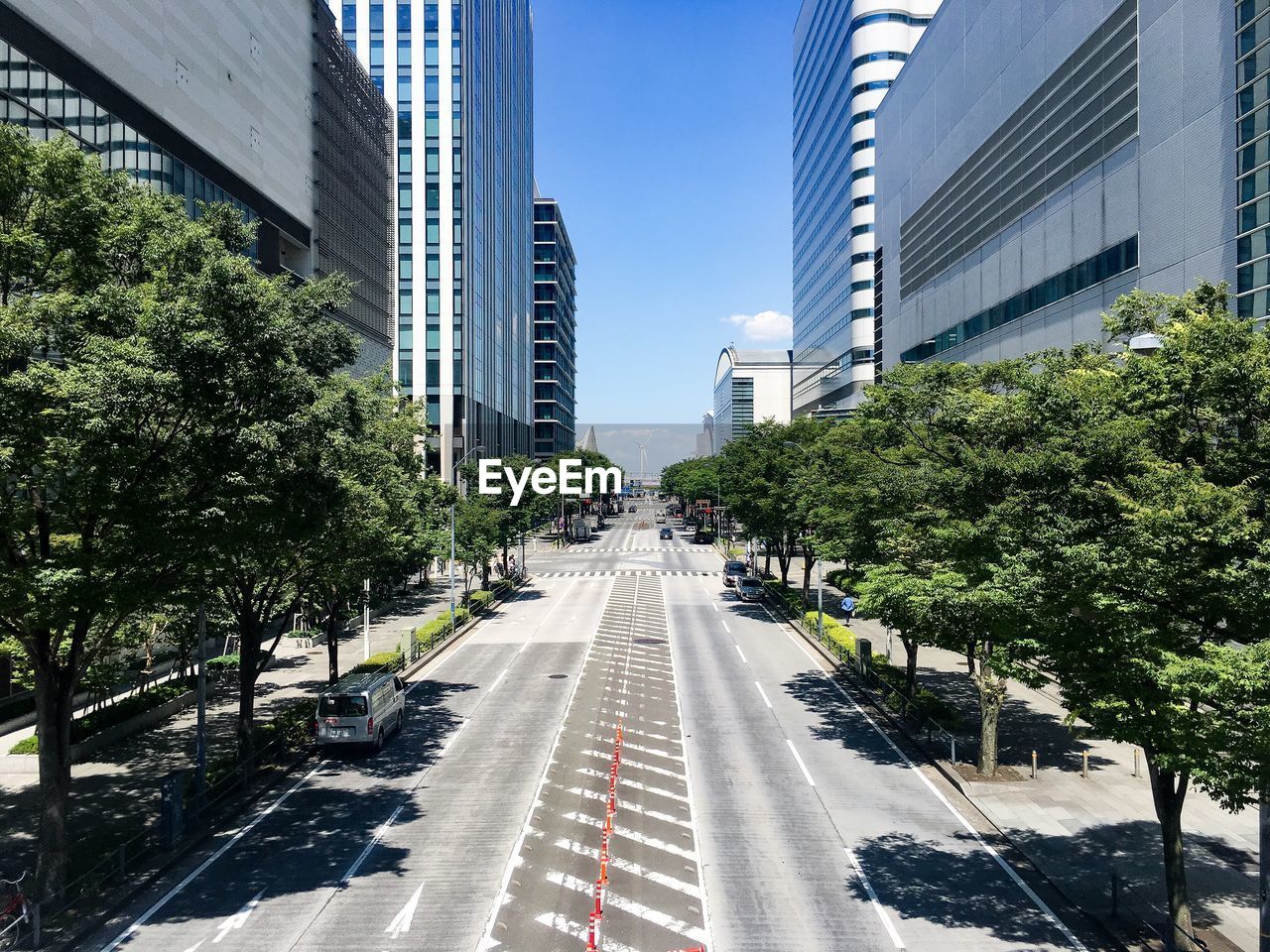 STREET AMIDST BUILDINGS AGAINST SKY