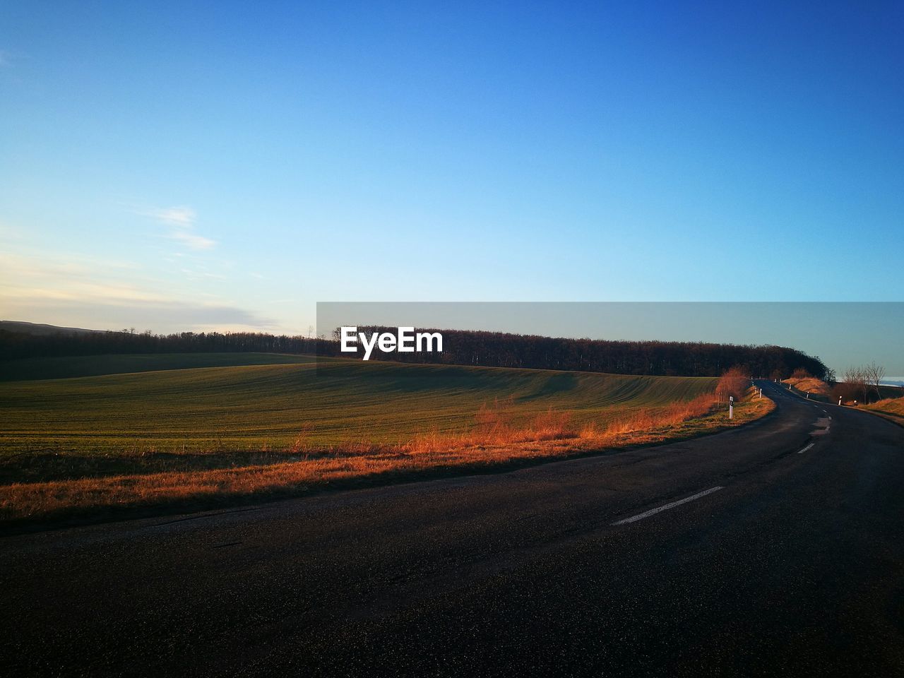 Highway against clear blue sky