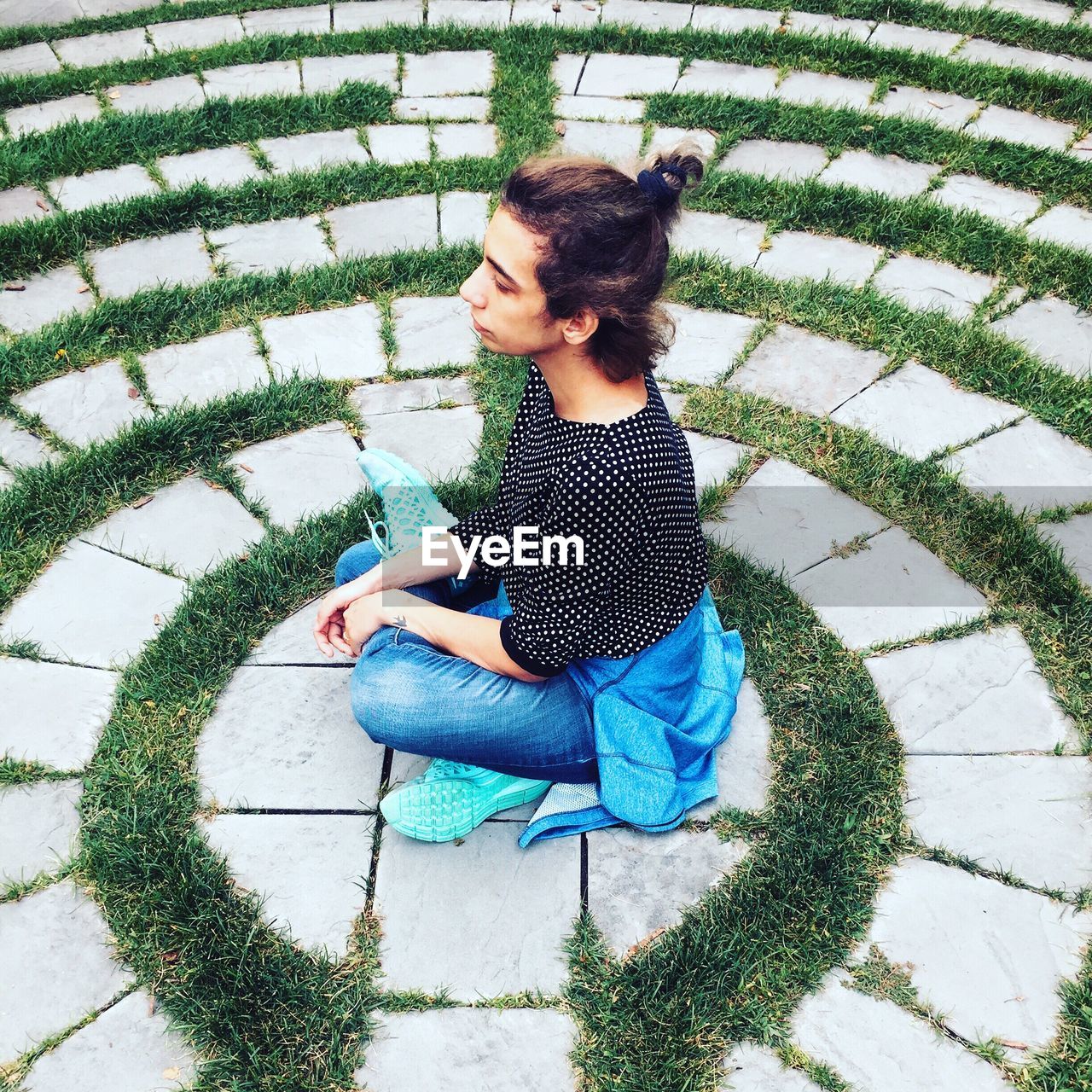 High angle view of young woman sitting on grass