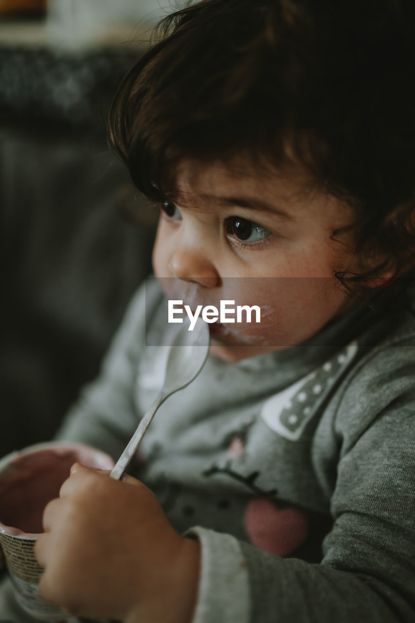 Portrait of cute child holding spoon