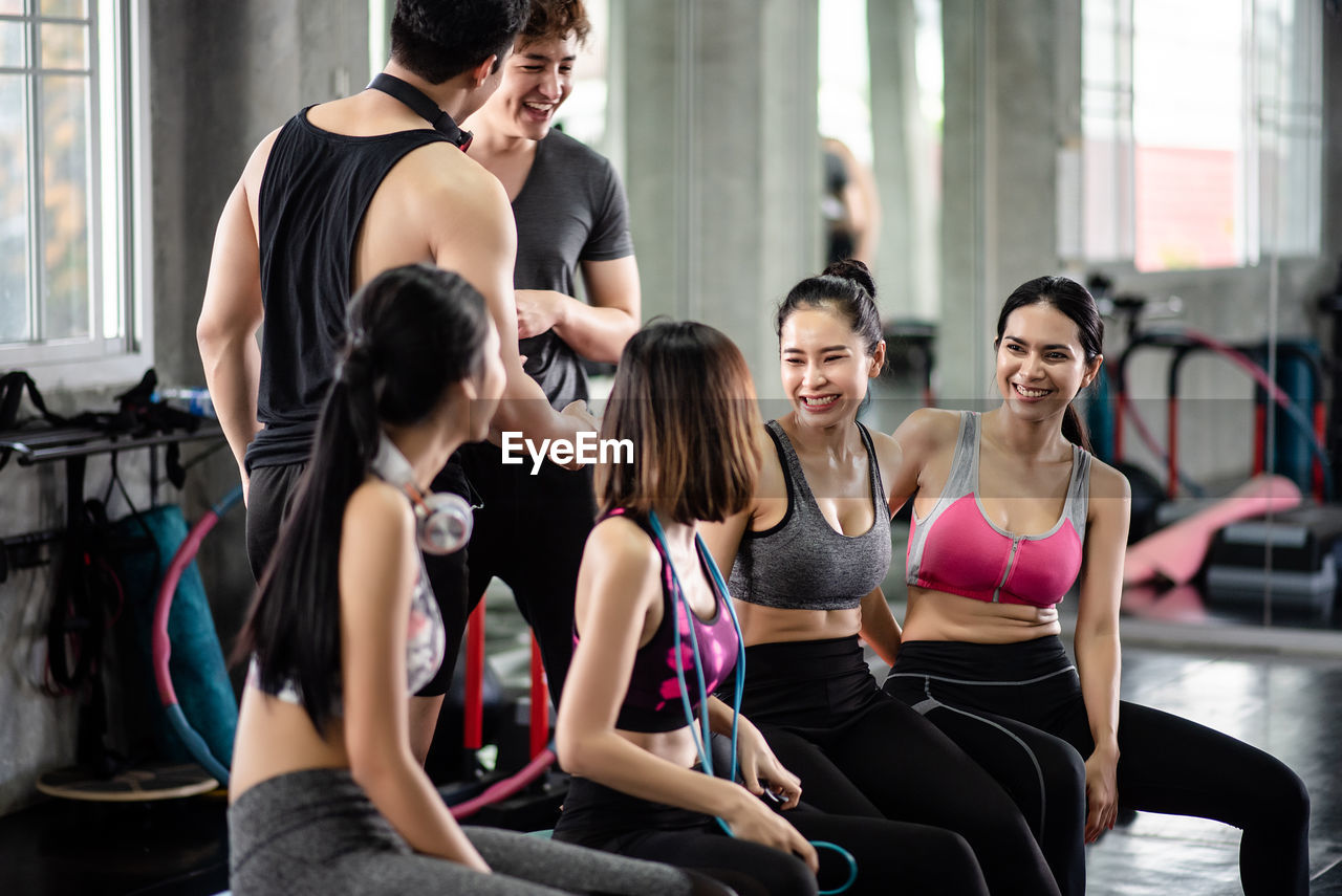 Smiling men and women at health club