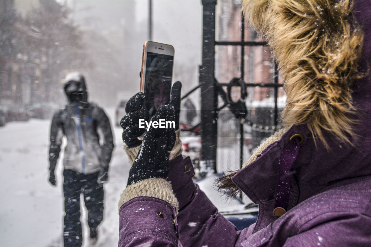 Close-up of woman photographing during winter