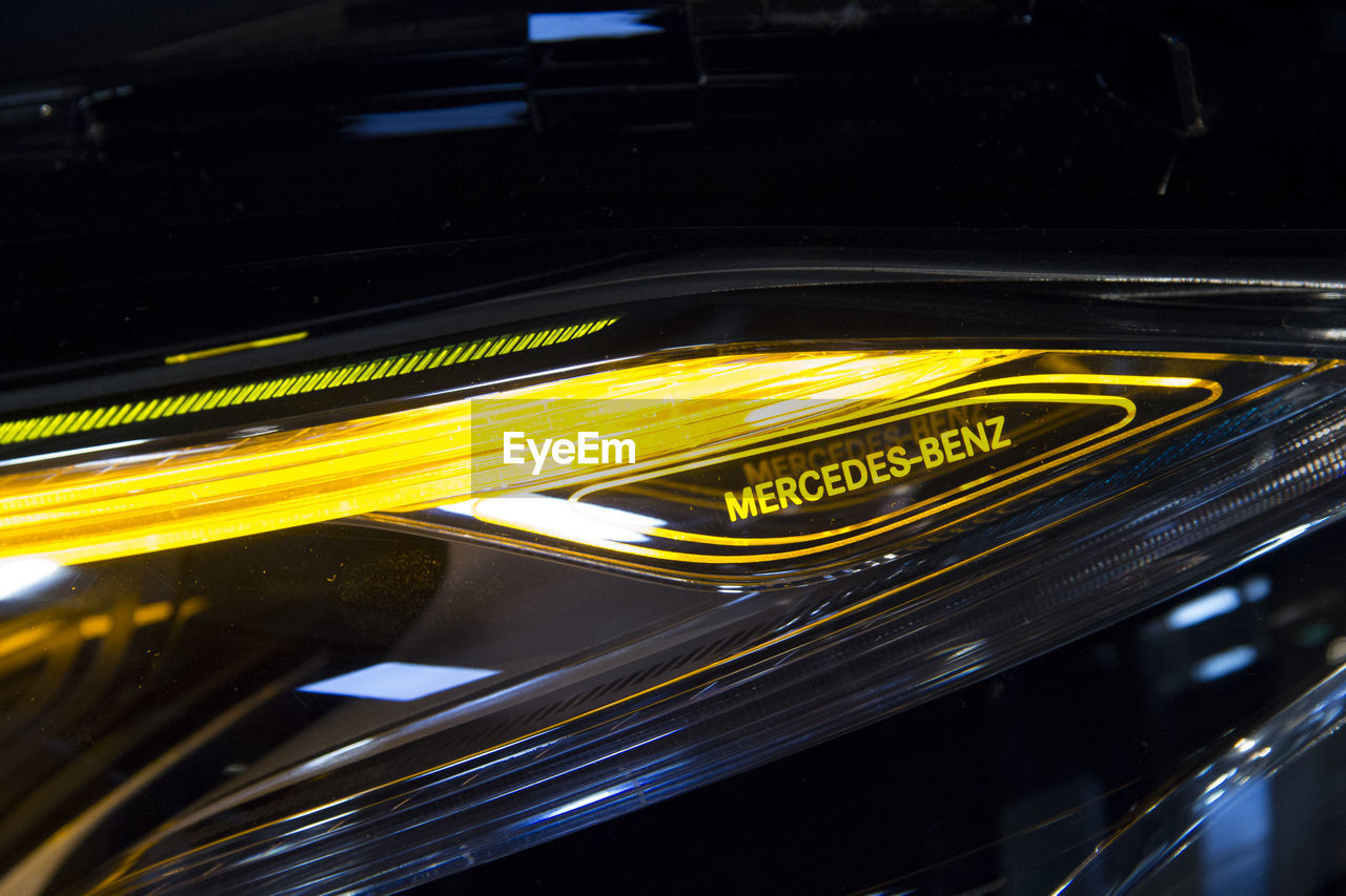 CLOSE-UP OF YELLOW LIGHTS IN CAR WINDSHIELD