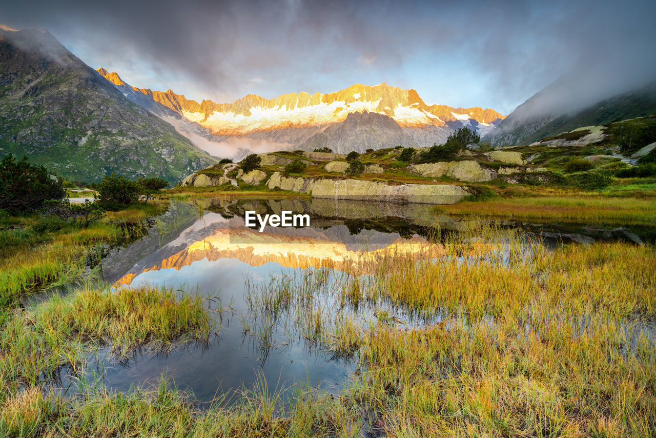 Scenic view of lake and mountains against sky