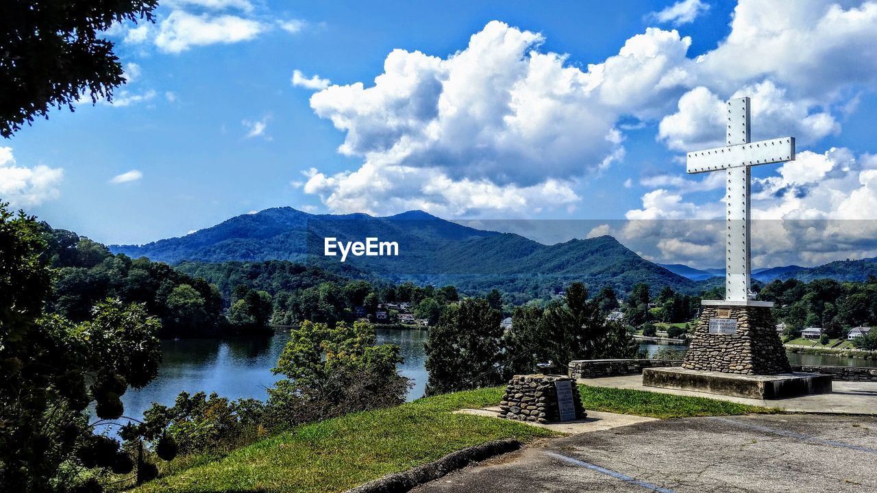 sky, cloud, mountain, nature, plant, tree, scenics - nature, architecture, water, mountain range, no people, beauty in nature, travel destinations, landscape, environment, tranquility, travel, religion, day, lake, tranquil scene, outdoors, built structure, blue, tourism, rural area, non-urban scene, belief, spirituality