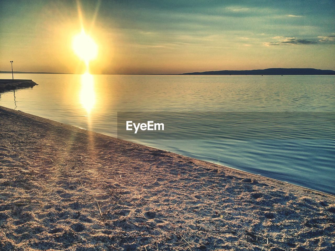 SCENIC VIEW OF BEACH AGAINST SKY DURING SUNSET