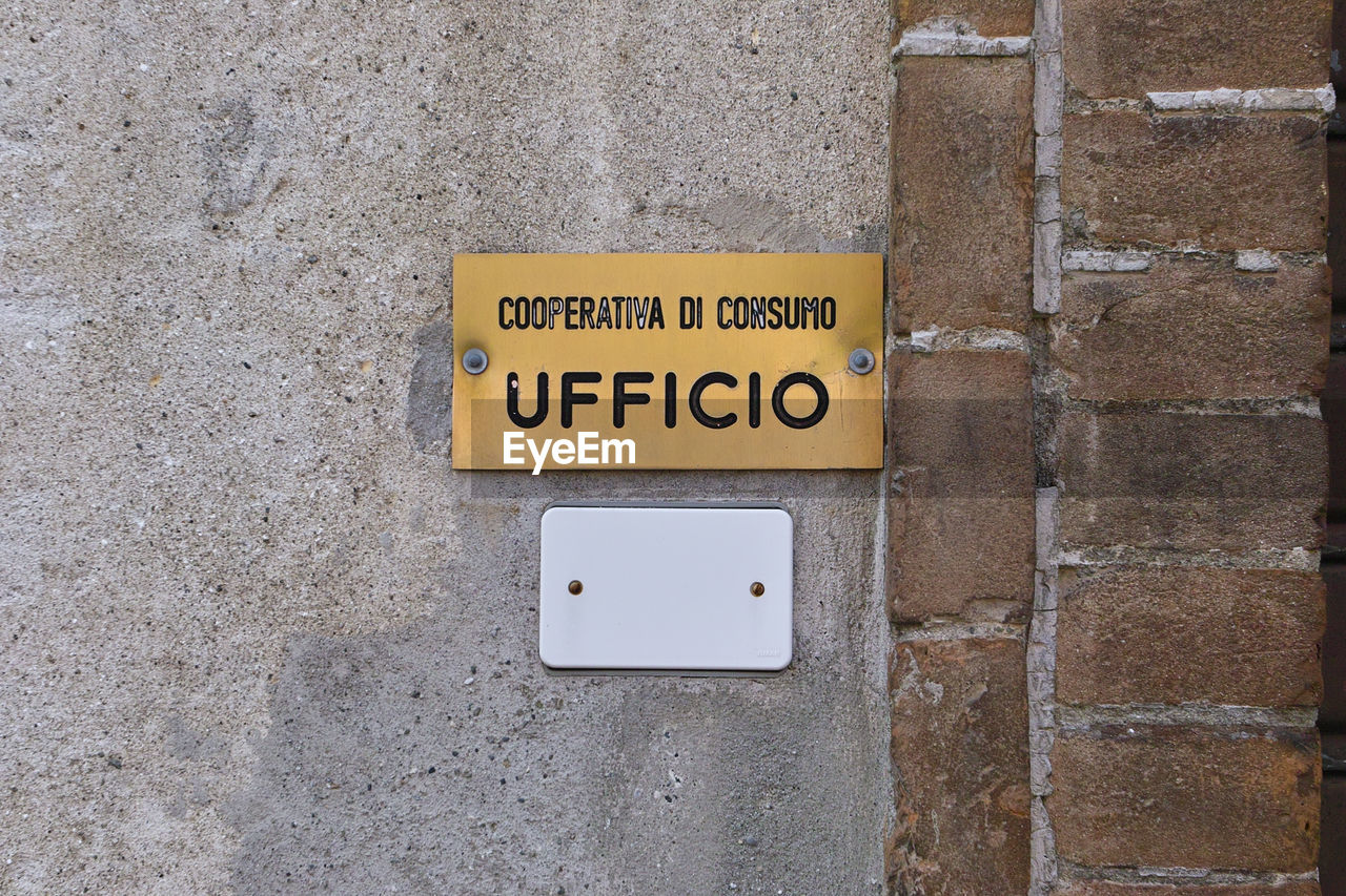 CLOSE-UP OF YELLOW TEXT ON WALL